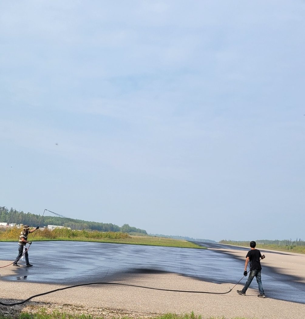 The Airport Guy crew sealing an Alberta airport runway