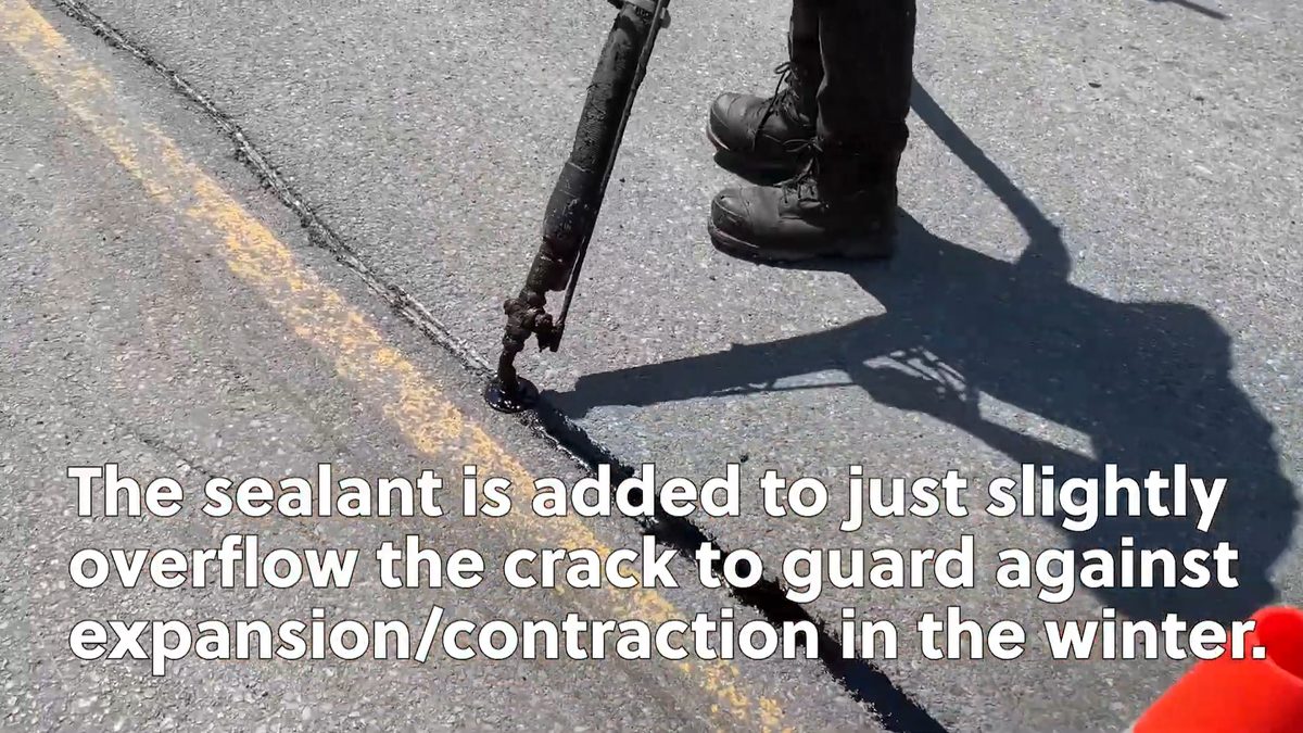 Hot rubber crack sealing application